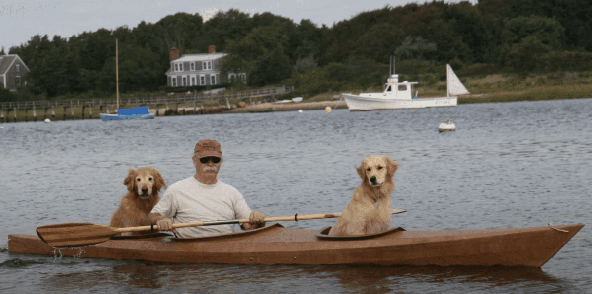 Vīrietis būvē pielāgotu kajaku, lai dalītos ūdens piedzīvojumos ar saviem diviem suņiem